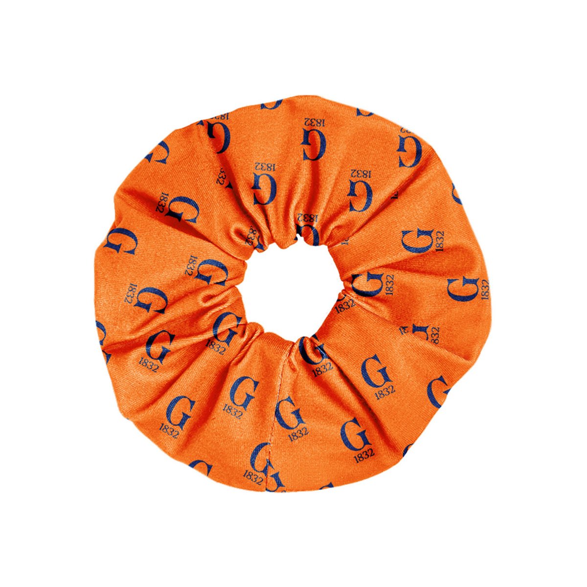 An orange fabric hair scrunchie featuring an all-over repeating navy blue monogram pattern of the letter 'G' with '1832' printed below it, shown against a plain white background.