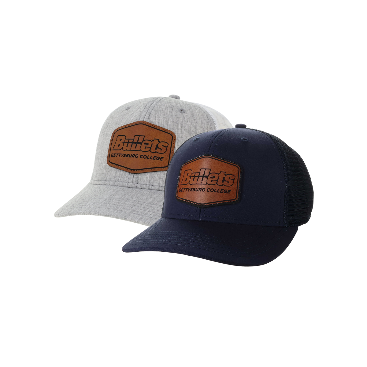 Two Gettysburg College Bullets trucker hats shown on a white background, one in heather light gray and one in navy blue. Both feature a brown leather patch on the front with the Bullets Gettysburg College branding.